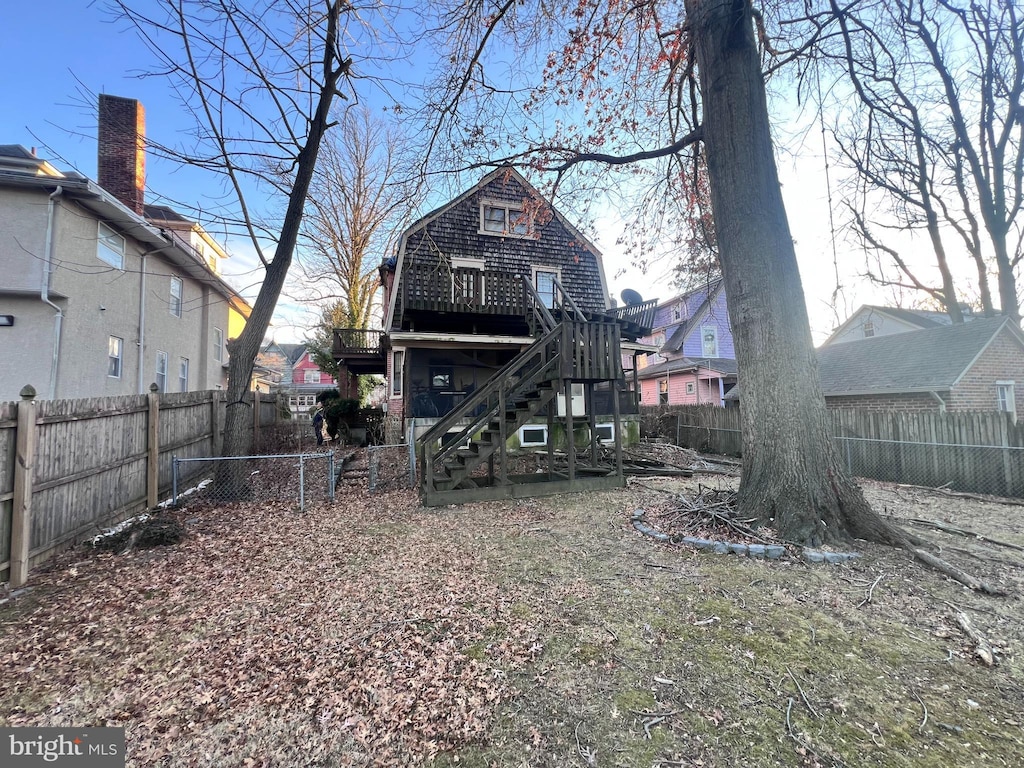 rear view of property featuring a wooden deck