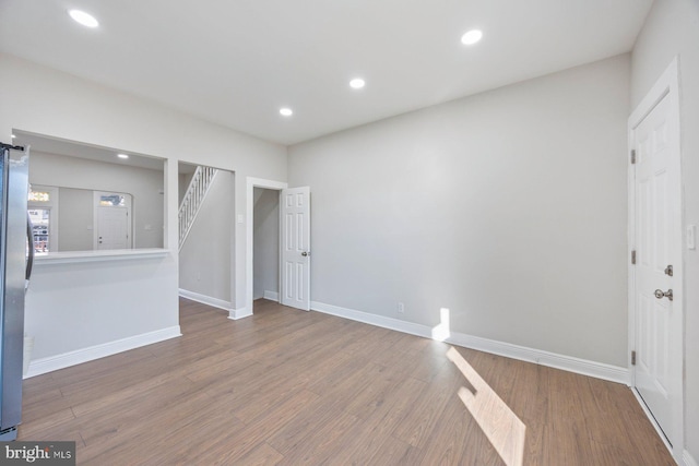 unfurnished living room featuring wood-type flooring