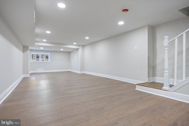 basement with hardwood / wood-style floors