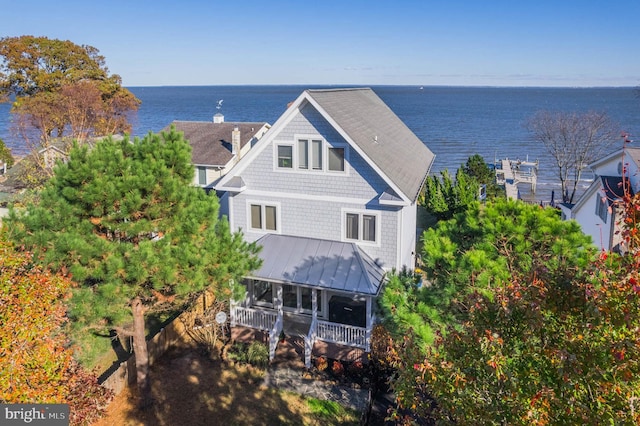 rear view of property with a water view