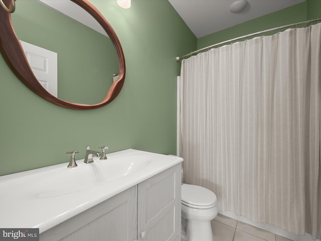 bathroom featuring vanity, toilet, curtained shower, and tile patterned flooring