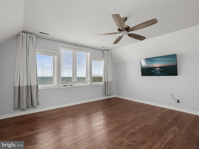 additional living space with dark wood-type flooring, ceiling fan, and vaulted ceiling