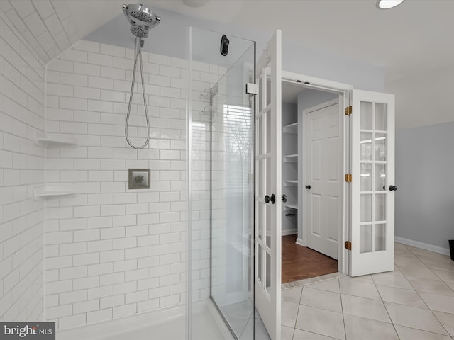 bathroom featuring tile patterned flooring, french doors, and a shower with shower door