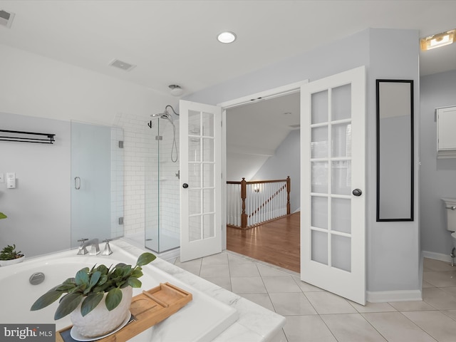 bathroom with french doors, tile patterned floors, and independent shower and bath