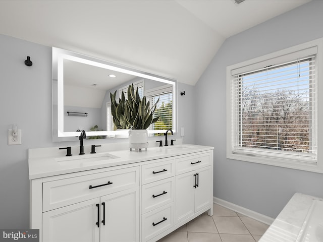 bathroom featuring vanity, vaulted ceiling, and tile patterned floors