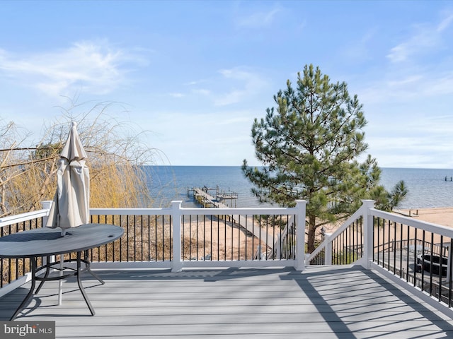 wooden terrace featuring a dock and a water view