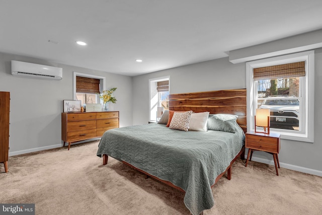 bedroom with multiple windows, light carpet, and a wall unit AC