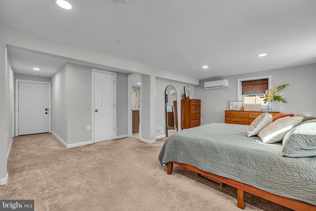 bedroom with a wall mounted AC and light carpet