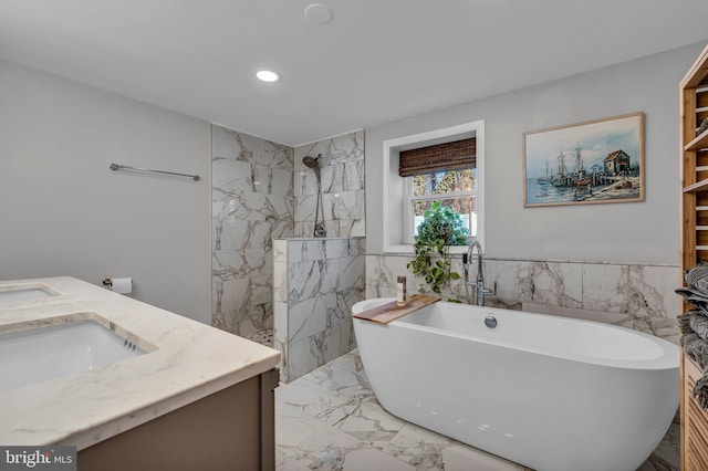 bathroom with vanity and a tub