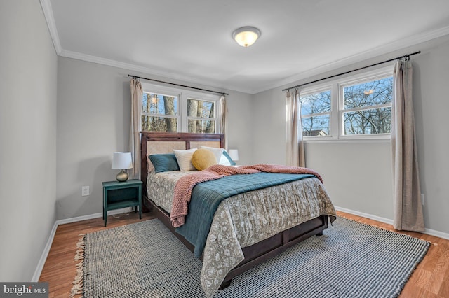 bedroom with ornamental molding and wood-type flooring