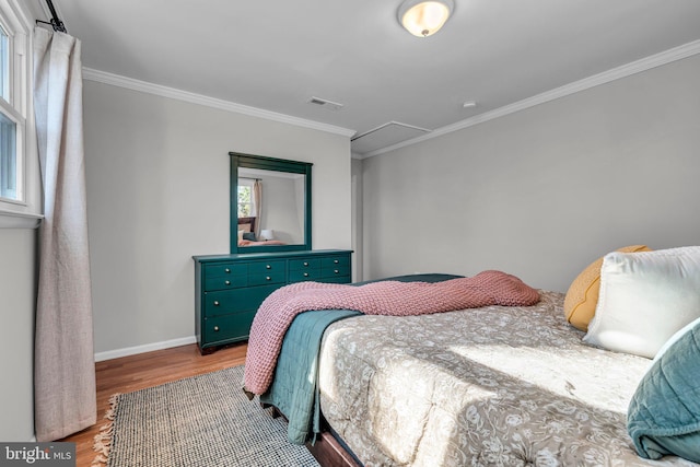 bedroom featuring hardwood / wood-style flooring and crown molding