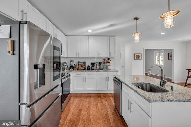 kitchen with sink, white cabinets, and appliances with stainless steel finishes