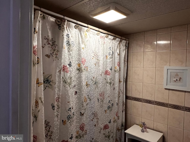 bathroom with tile walls