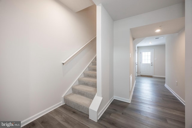 staircase with wood-type flooring