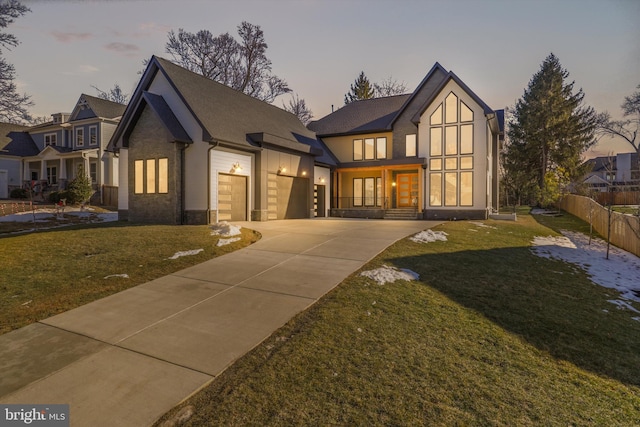 view of front of house featuring a garage and a yard