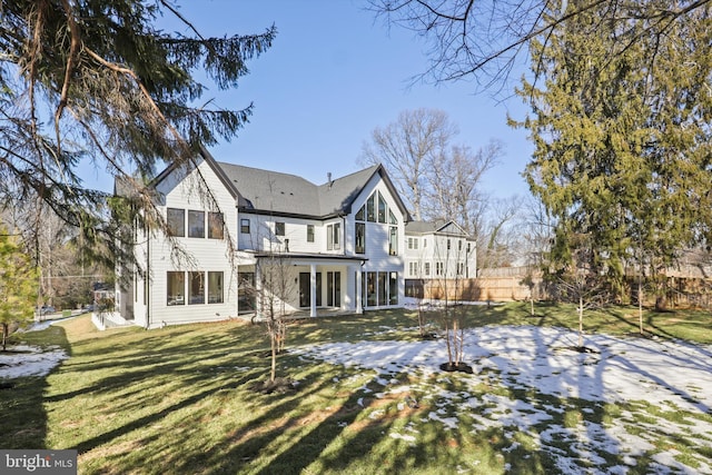 rear view of house with a yard