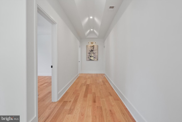 corridor with light hardwood / wood-style floors