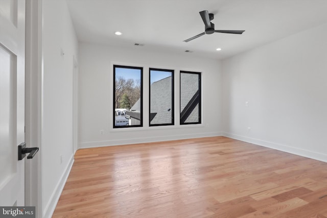 spare room with ceiling fan and light wood-type flooring