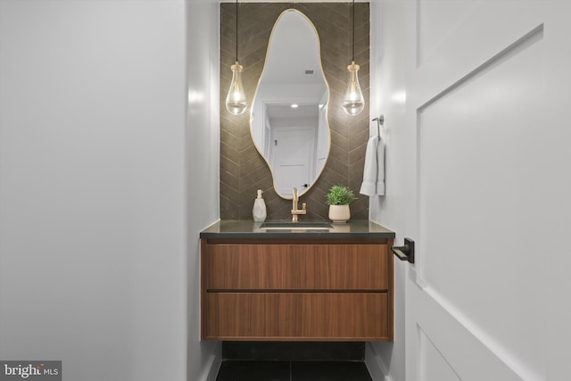 bathroom featuring vanity, tile patterned floors, and backsplash