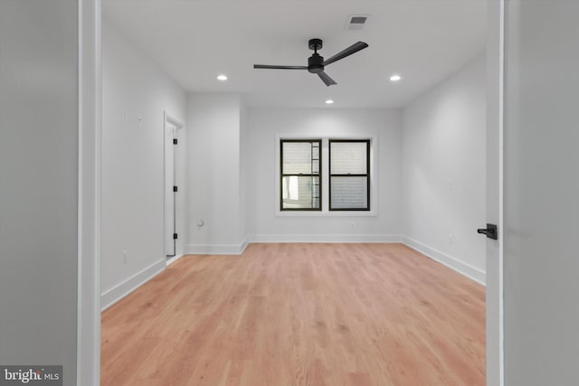 empty room with light hardwood / wood-style flooring and ceiling fan