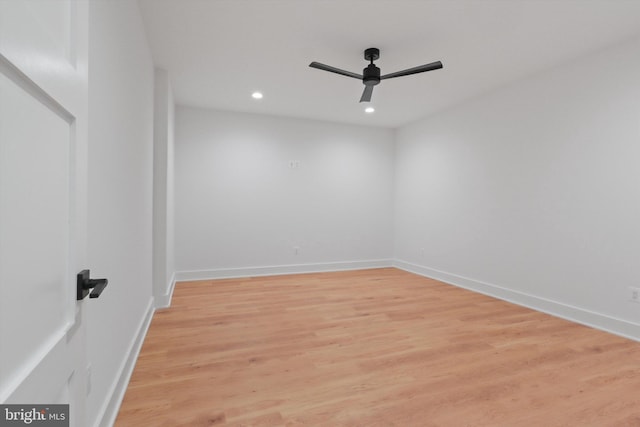 spare room with ceiling fan and light wood-type flooring