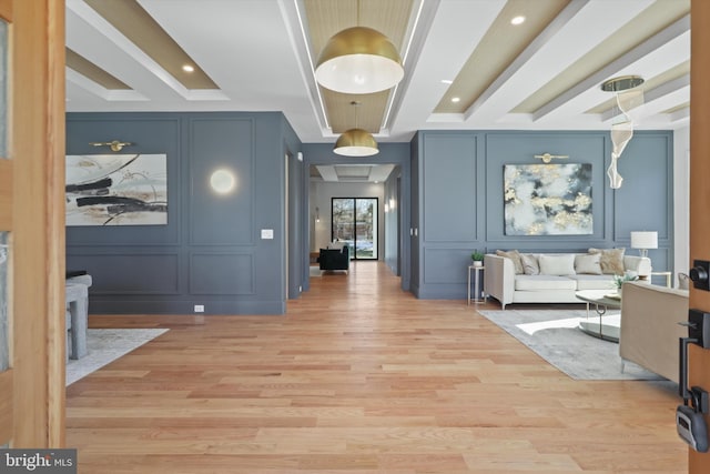 hall featuring a raised ceiling and light wood-type flooring