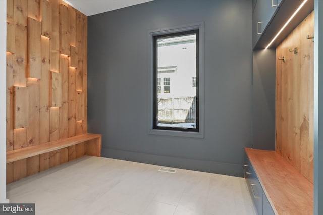 mudroom with wooden walls