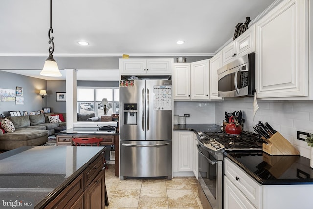 kitchen with white cabinetry, appliances with stainless steel finishes, and pendant lighting