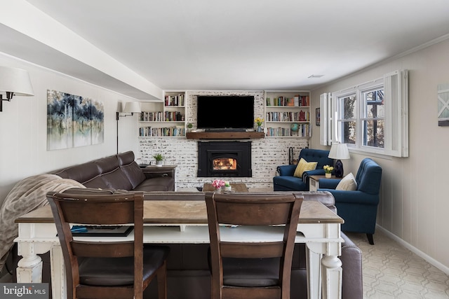 living room with a large fireplace and built in features