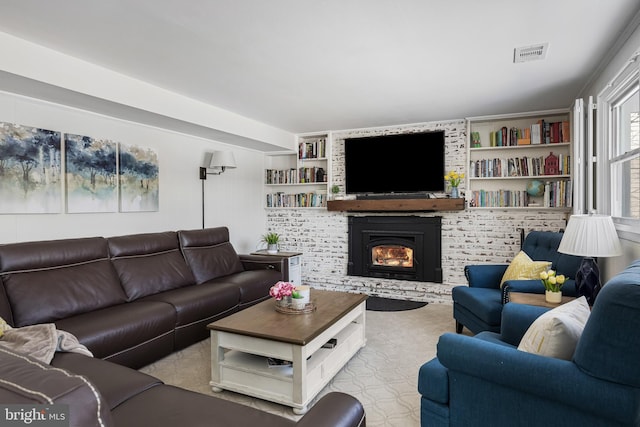 living room featuring a large fireplace and built in shelves