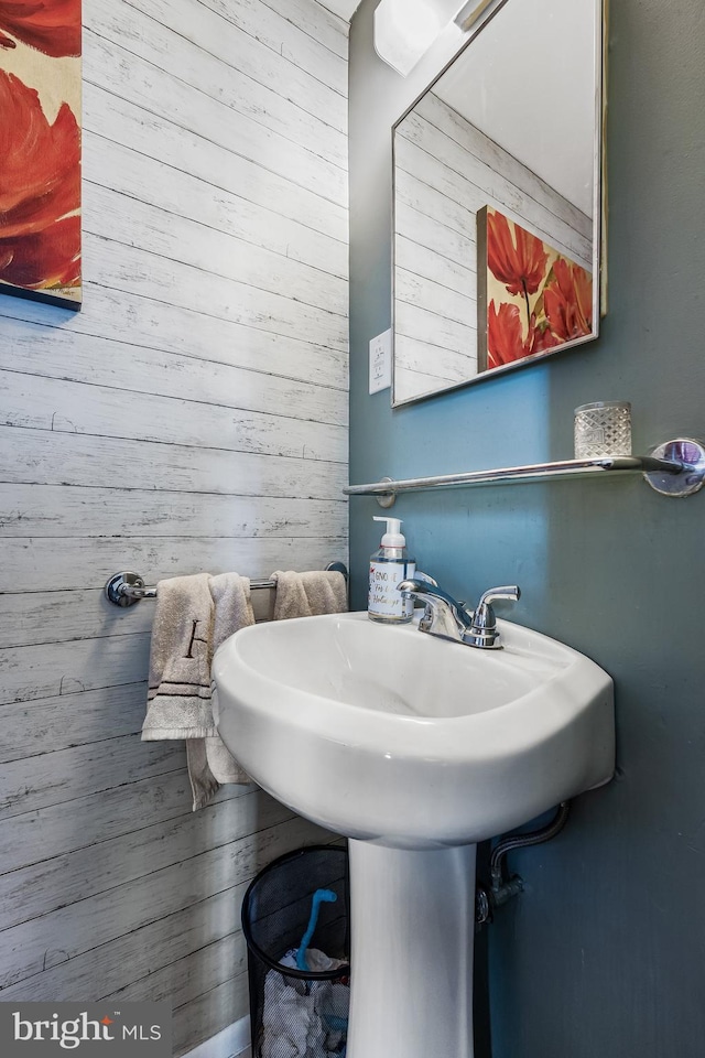 bathroom featuring wood walls