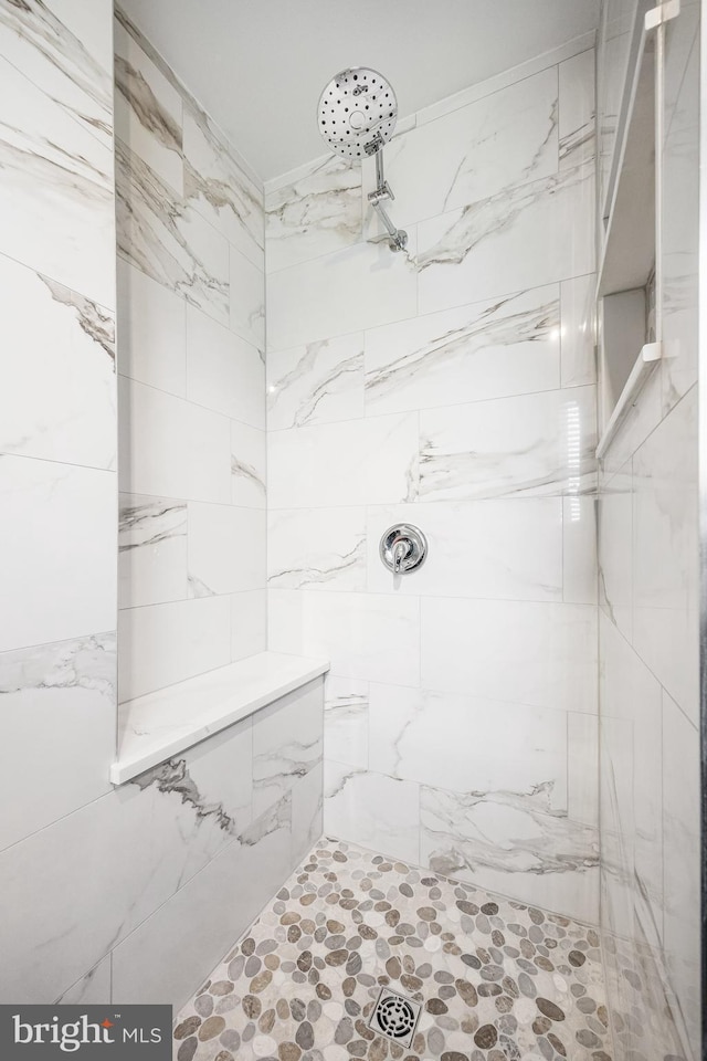 bathroom with a tile shower