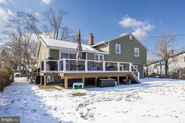 snow covered property featuring a wooden deck