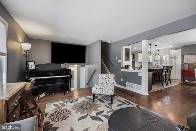 living room with sink and dark hardwood / wood-style floors