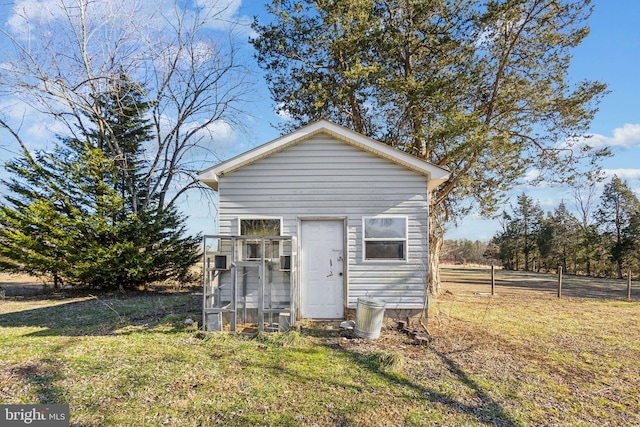 view of outbuilding featuring a yard