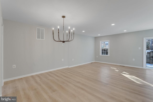 interior space with a notable chandelier and light hardwood / wood-style flooring