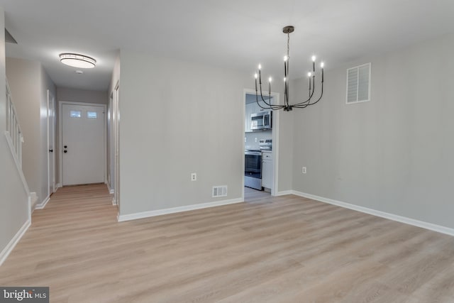 unfurnished dining area featuring a notable chandelier and light hardwood / wood-style flooring