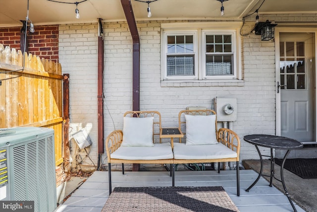 view of patio / terrace with central air condition unit and fence