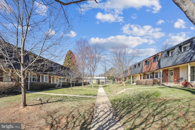 view of community with a yard and a residential view