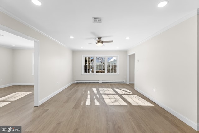 spare room featuring a baseboard heating unit, ornamental molding, light hardwood / wood-style floors, and ceiling fan