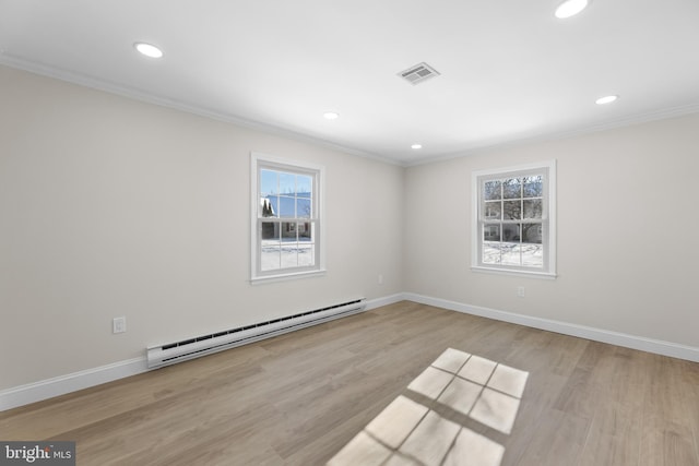 unfurnished room featuring crown molding, a baseboard heating unit, and light hardwood / wood-style flooring