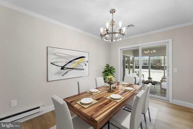 dining room with an inviting chandelier, a baseboard heating unit, ornamental molding, and light hardwood / wood-style floors