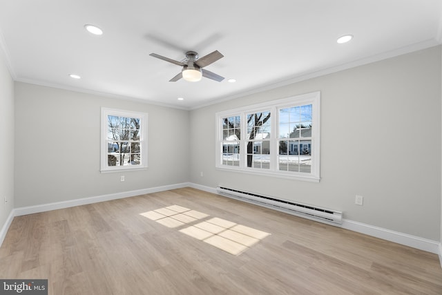 spare room with ceiling fan, ornamental molding, light hardwood / wood-style floors, and a baseboard heating unit