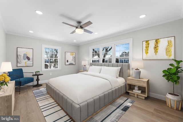 bedroom featuring ceiling fan, ornamental molding, and light wood-type flooring