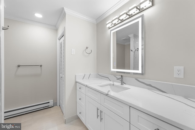 bathroom featuring baseboard heating, ornamental molding, and vanity