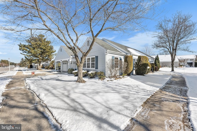 snow covered property featuring a garage