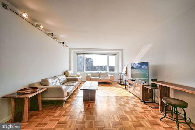 living room featuring light parquet flooring and track lighting