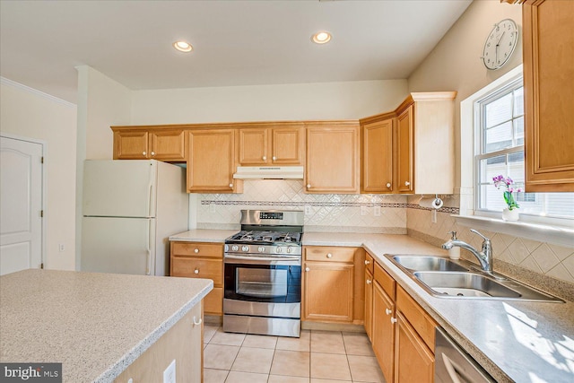 kitchen with tasteful backsplash, appliances with stainless steel finishes, sink, and light tile patterned floors