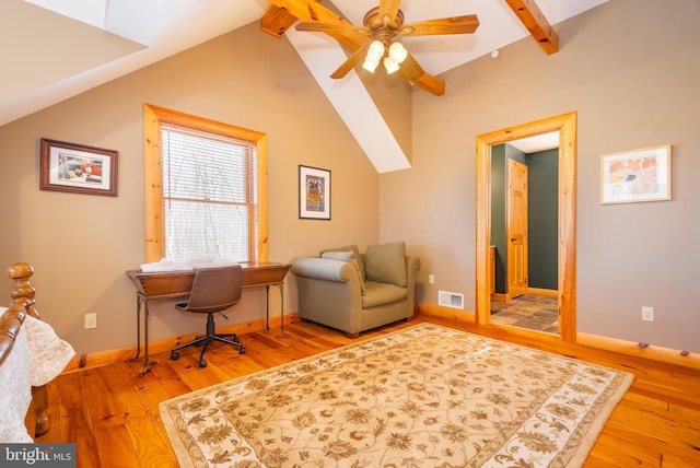 office space featuring hardwood / wood-style flooring, lofted ceiling with beams, and ceiling fan