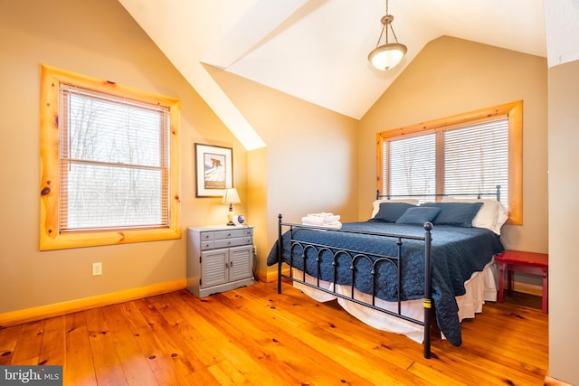 bedroom featuring lofted ceiling and light hardwood / wood-style floors